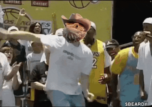 a man wearing a cowboy hat is dancing in front of a crowd of people