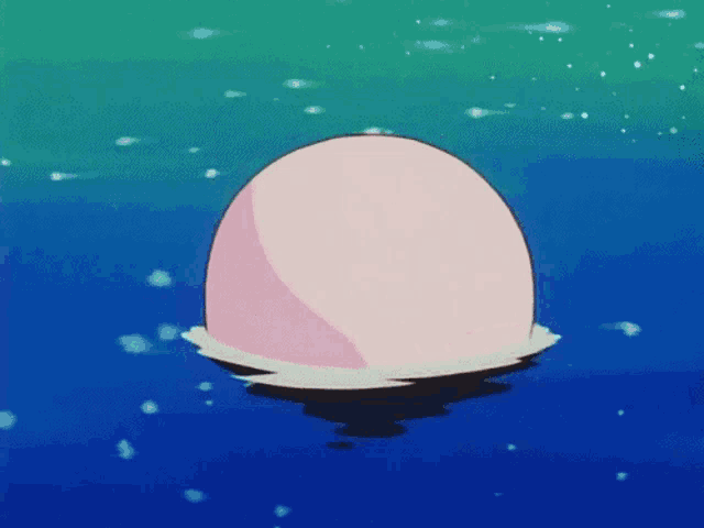 a pink ball is floating on top of a body of water