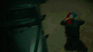 a man wearing a mask stands in front of a black car