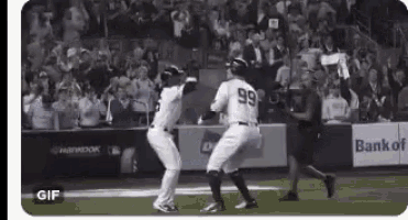 a baseball player with the number 99 on his jersey is dancing on the field with another player .