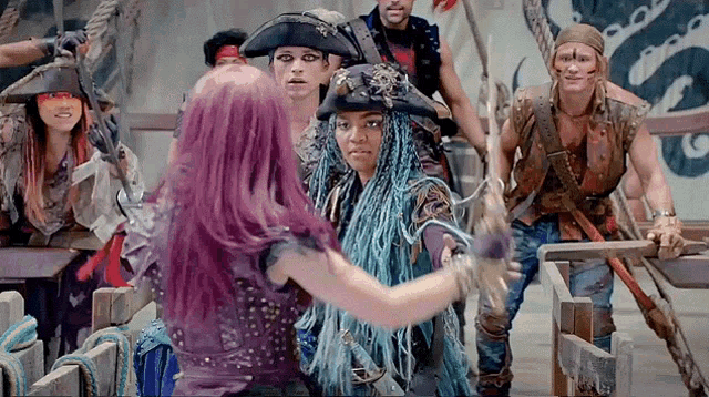 a woman with purple hair is hugging another woman
