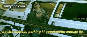 a man is sitting in a car with his hands on his chest and a caption that says bayara manollu parking