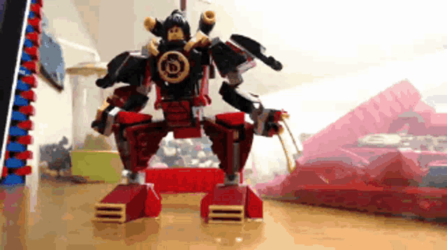 a lego robot is sitting on a table next to a box of lego
