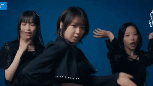 three girls are dancing in front of a sign that says cnt