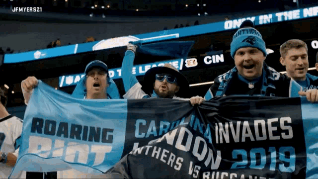 a group of people holding up a banner that says roaring shot