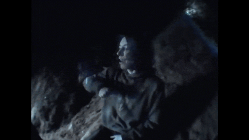a person is standing in a dark room with smoke coming out of it