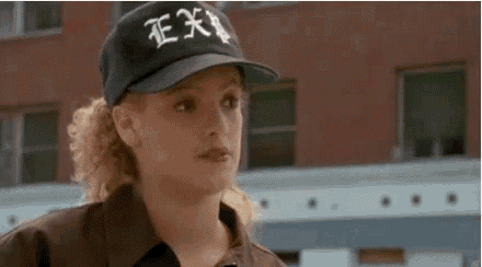 a woman wearing a black baseball cap with the word ex on it .