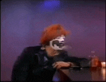 a blurred image of a clown sitting at a table