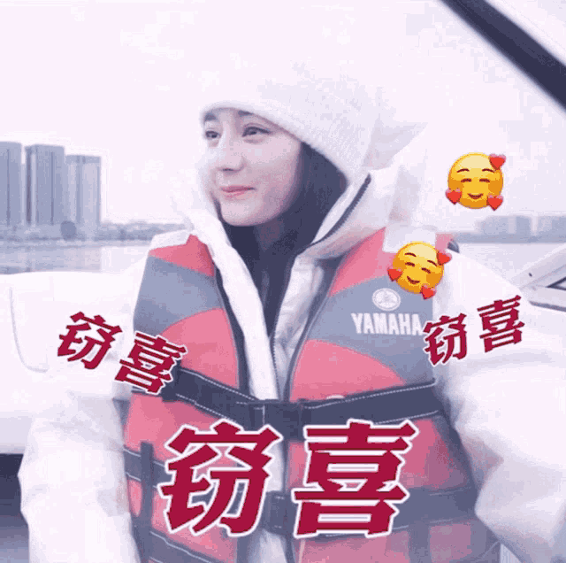 a woman wearing a red and black yamaha life vest
