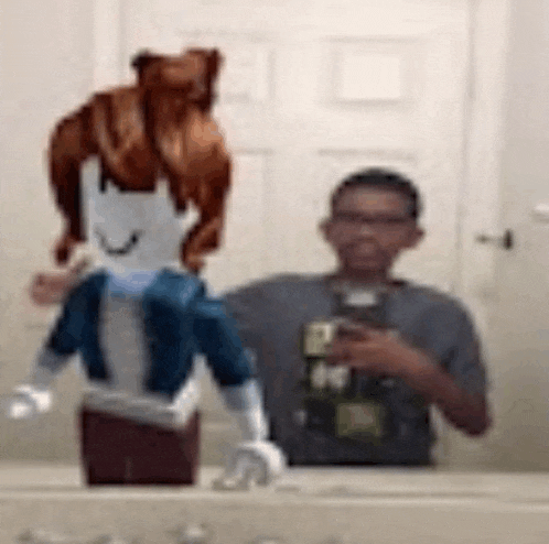 a man is taking a picture of himself in a bathroom mirror with a stuffed animal on his head .