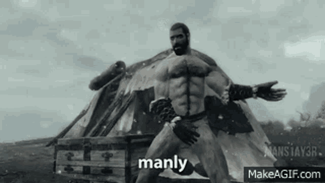 a man with a beard is standing in front of a tent with the word manly written on it .