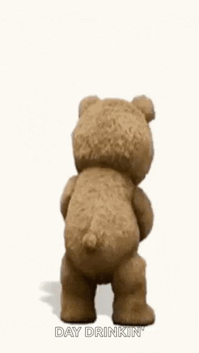 a teddy bear is holding a shaker and a glass of wine while dancing .