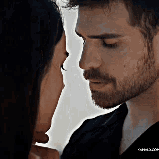 a close up of a man and woman looking into each other 's eyes with kanald.com written on the bottom