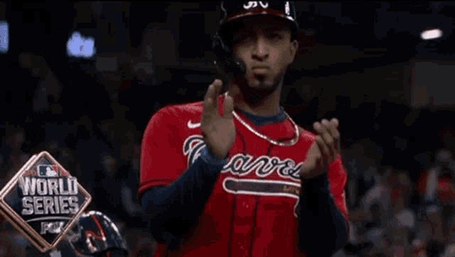 a baseball player is applauding during the world series