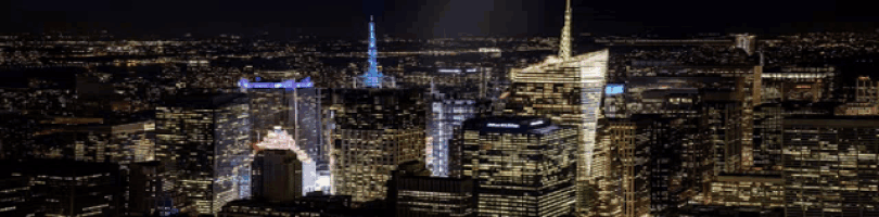 an aerial view of a city at night with a skyscraper that says ' chase ' on it