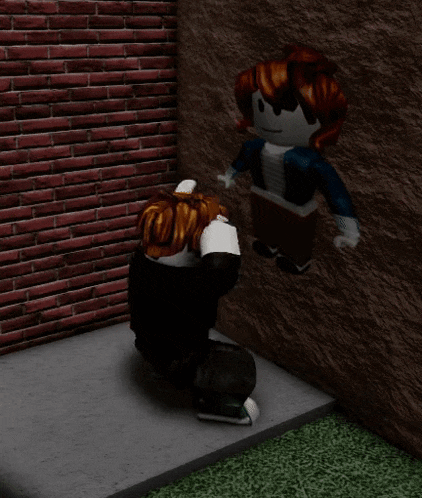 a girl kneeling down in front of a brick wall