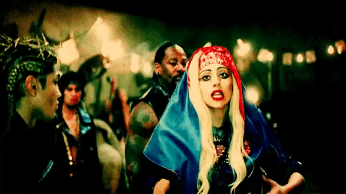 a woman in a red white and blue outfit stands in a crowd of people