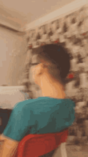 a blurry picture of a man sitting in a chair
