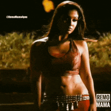 a woman in a red crop top and red pants is standing in front of a sign that says remo mama