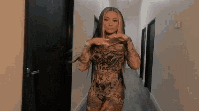 a woman is standing in a hallway wearing a bodysuit with the year 1995 on it