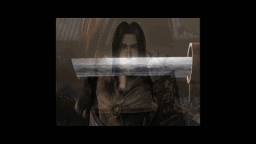 a man with long hair is holding a sword in a dark room