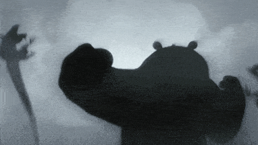 a black and white image of a hippopotamus in a foggy area