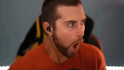 a man with a beard is wearing headphones and making a face .