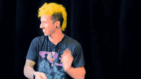 a man with yellow hair is wearing a black shirt