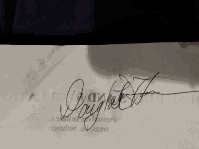 a close up of a person 's signature on a piece of paper that says " joyful "