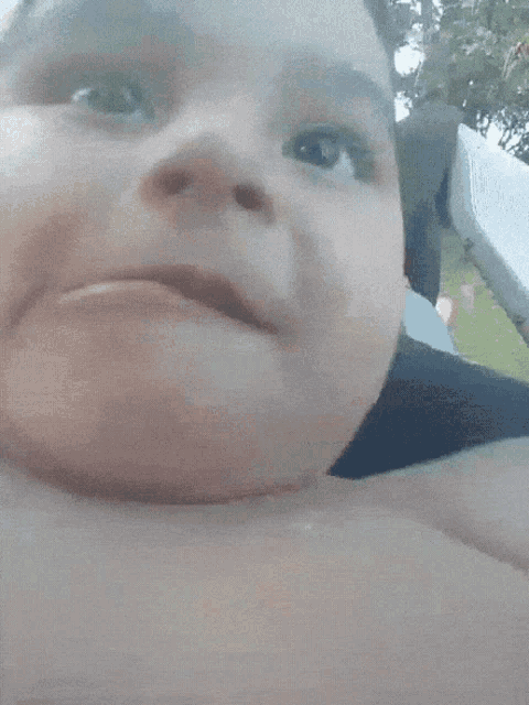 a close up of a child 's face with a serious look on it