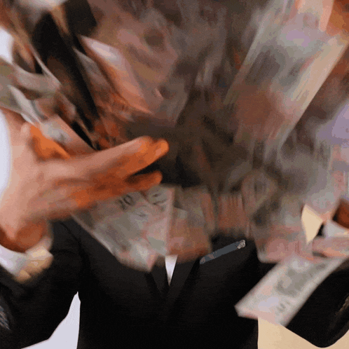 a man in a suit is holding a stack of money that says 10