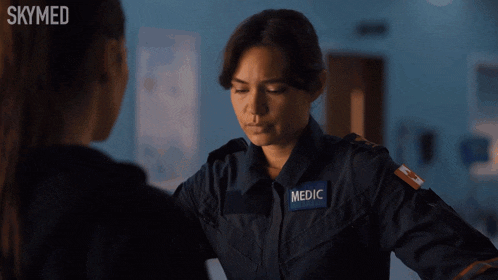 a woman in a skymed uniform is talking to another woman
