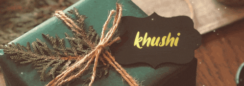 a gift wrapped in green paper with a label that says khushi