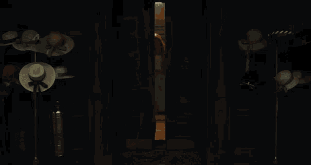 a person is holding a glass bottle with a brown liquid inside of it