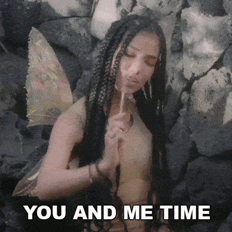 a woman in a fairy costume is holding a lollipop and saying you and me time