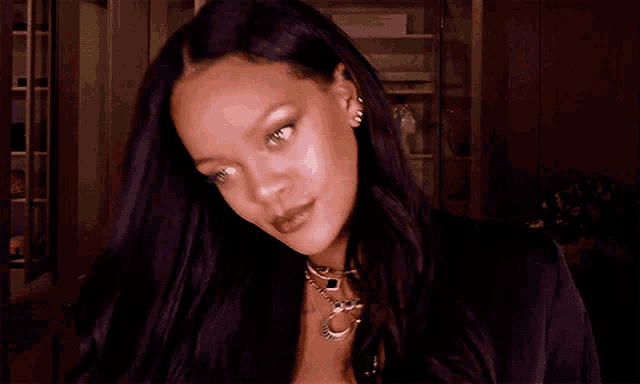 a close up of a woman 's face with the word rihanna on her neck