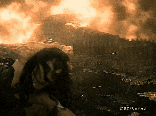 a picture of a woman in front of a fire with the words dcfunited on the bottom