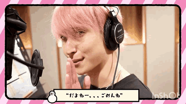 a man with pink hair wearing headphones that say sony