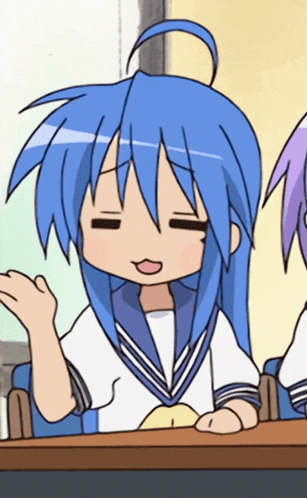 a girl with blue hair is sitting at a table