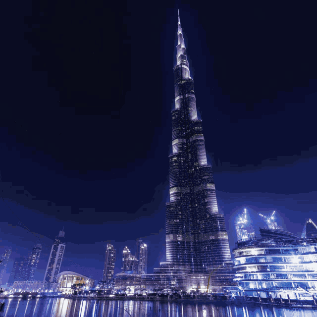 the tallest building in the world is lit up at night in a city