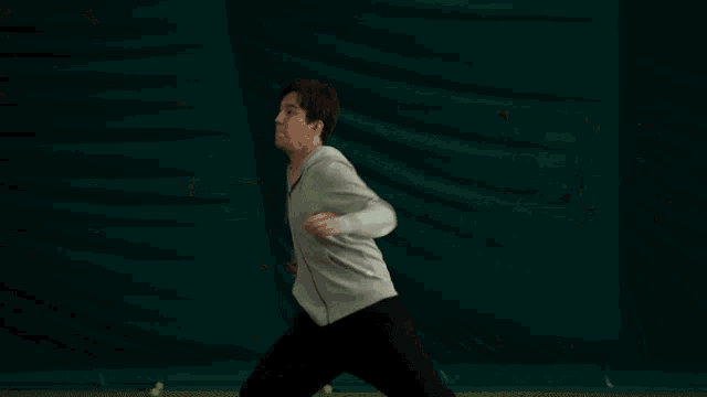 a person playing tennis in an indoor dome