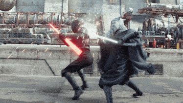 a man in a black cape is fighting another man with a red lightsaber