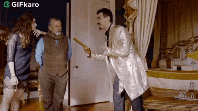 a man in a white coat is pointing a gun at a man in a brown vest .