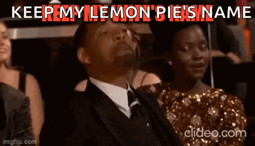 a man in a suit and tie is sitting in a crowd and says " keep my lemon pie 's name " .