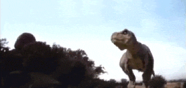 a t-rex is standing in the dirt and looking at the camera