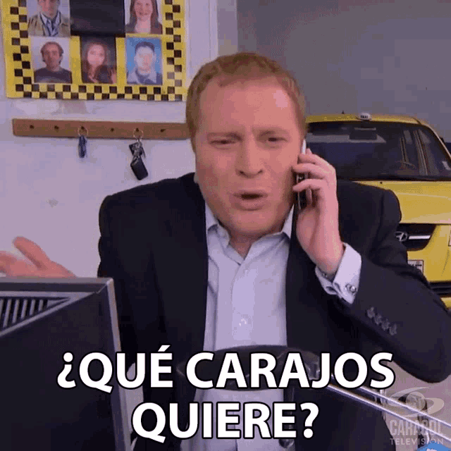 a man in a suit is talking on a cell phone and says " que carajos quiere " in spanish