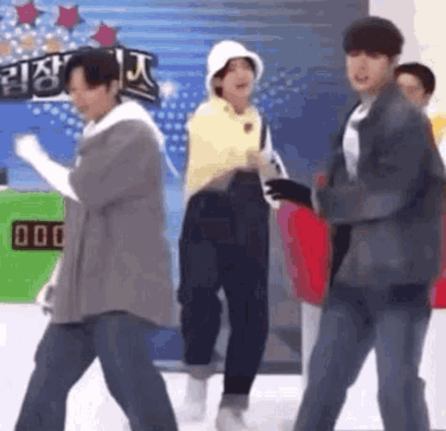 a group of people are standing next to each other and dancing .