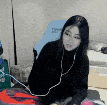 a woman wearing headphones sits in front of a blue chair that says trade