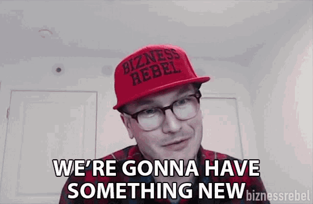 a man wearing a red hat that says bizness rebel on it
