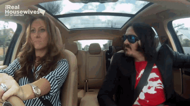 a man and a woman are sitting in a car with the words real housewives out of context above them